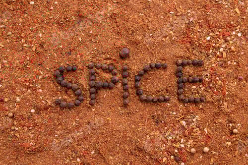 Preview: Top view of the inscription spices made from red capsicum ground pepper and cinnamon on the table