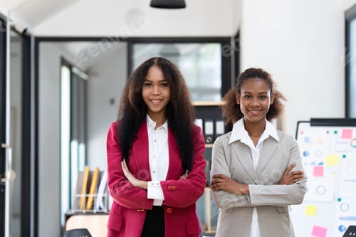 Preview: A young African-American businesswoman stands for a couple's photo. Join the way of doing business o