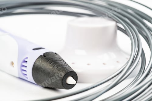 Preview: 3D printing pen lie near colorful rolled wires