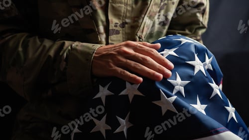 Preview: Soldier caressing the stars of a usa Flag on veterans day