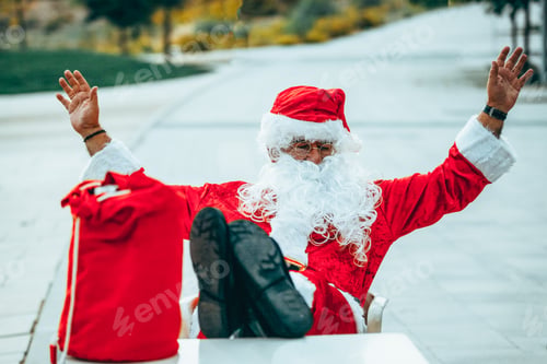 Preview: Santa Claus sitting in a chair with open arms with an expression of surprise and happiness