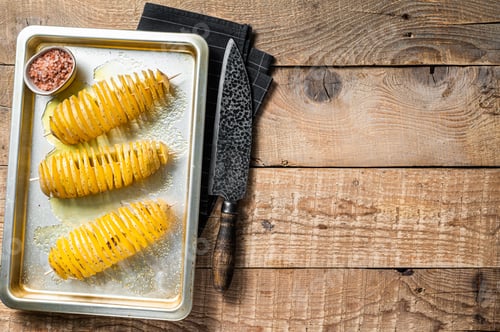 Preview: Uncooked raw Tornado or Twist potato fries. Wooden background. Top view. Copy space