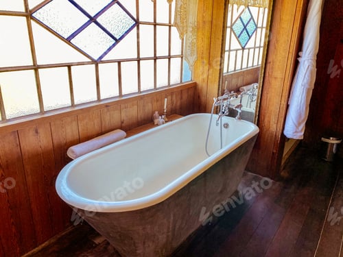 Preview: Freestanding bathtub next to a window.