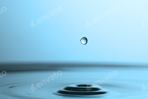 Preview: Drop falling into clear water on light grey background, closeup