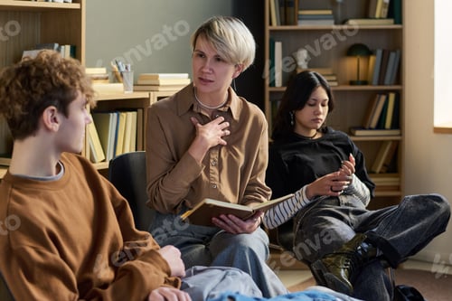 Preview: Adult Woman Leading Group Therapy Session with Teenagers