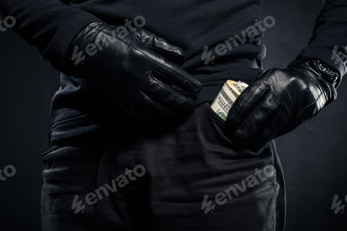 Preview: Close-up view of dollar banknotes in pocket of thief