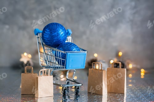 Preview: Holiday shopping. Shopping cart with blue shiny balls and paper bags