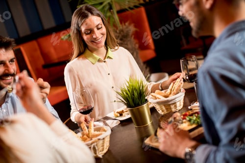 Preview: Young people having dinner in the restaurant