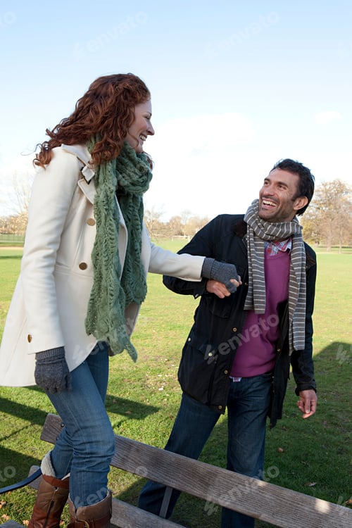 Preview: Couple sharing a joyful moment in a sunny park