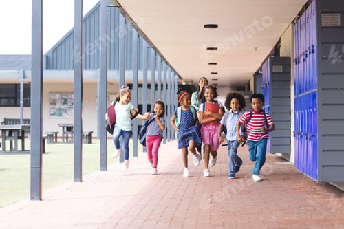 Preview: In school, a diverse group of students are running down a hallway outdoors