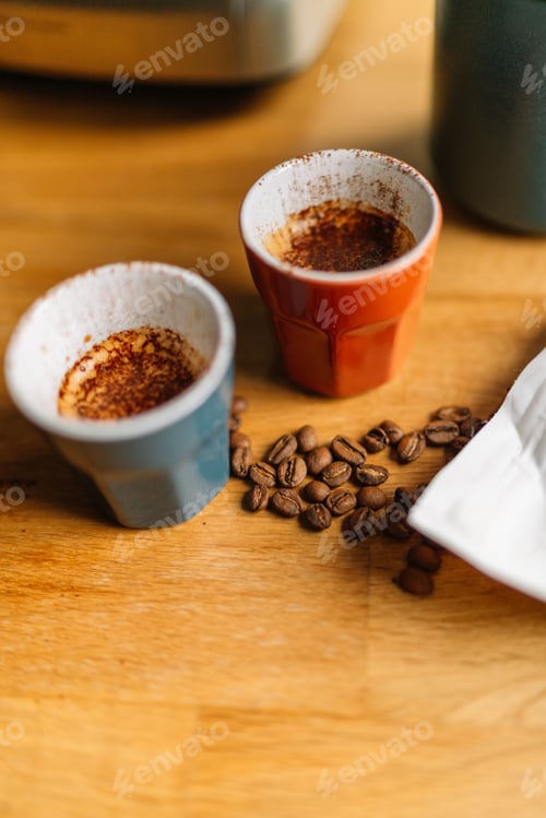 Preview: Two espresso cups with coffee beans on a wooden table