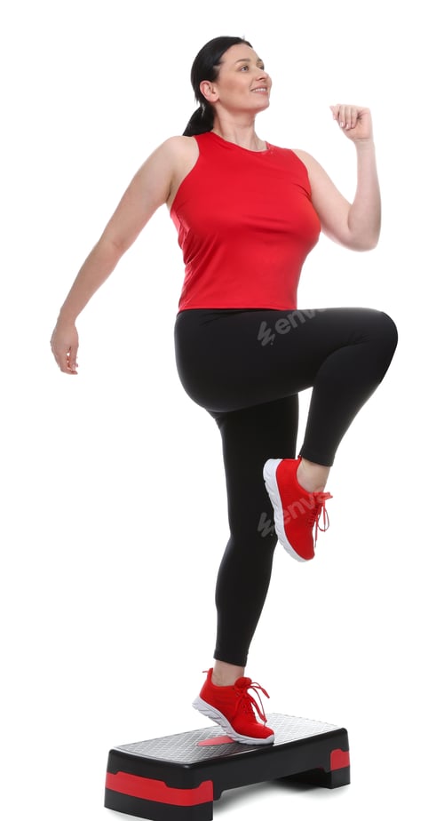 Preview: Plus size woman in gym clothes doing exercise with step platform on white background