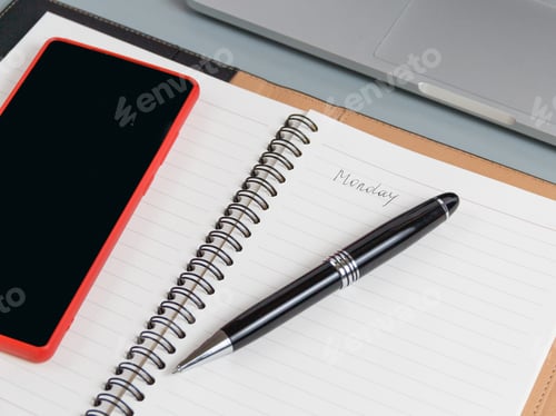 Preview: Opened agenda with handwritten MONDAY on a grey close up