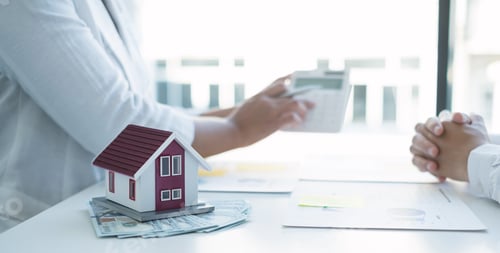 Preview: Two real estate agents discuss a financial chart showing the results, analyzing and calculating