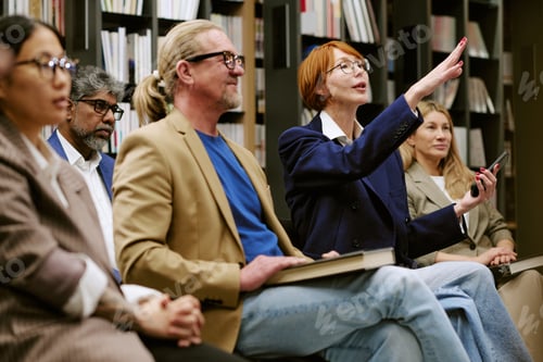 Preview: Diverse Group of Adults Attending Presentation and Engaging with Speaker