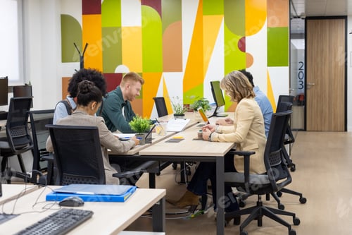 Preview: Diverse business people collaborating in vibrant modern office