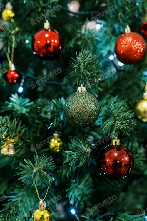 Preview: Bright sparkling green and red balls hang on the branches of the Christmas tree