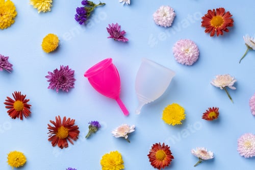 Preview: Menstrual cup on floral pattern background top view