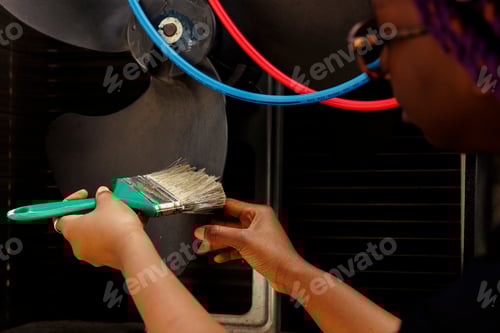 Preview: Mechanic removing dust from blower fan
