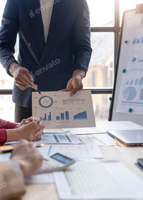 Preview: Business People Meeting using laptop computer,calculator,notebook,stock market chart paper for