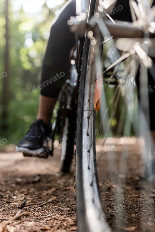 Preview: woman riding bike in city park