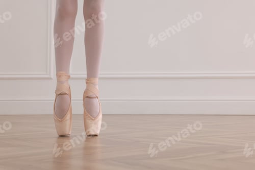 Preview: Little ballerina practicing dance moves in studio, closeup of legs. Space for text