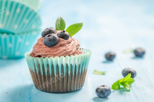 Preview: Delicious Cupcake with Brown Frosting and Blueberries