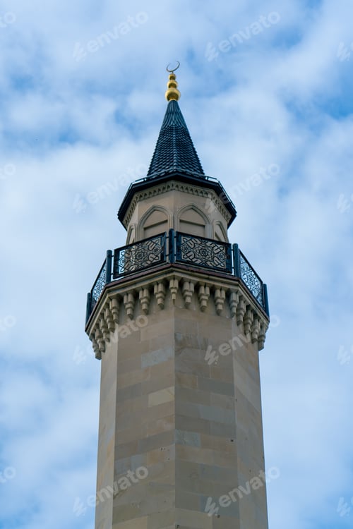 Preview: Close-up shot of a minaret tower with a balcony in a Muslim mosque against a bright blue sky