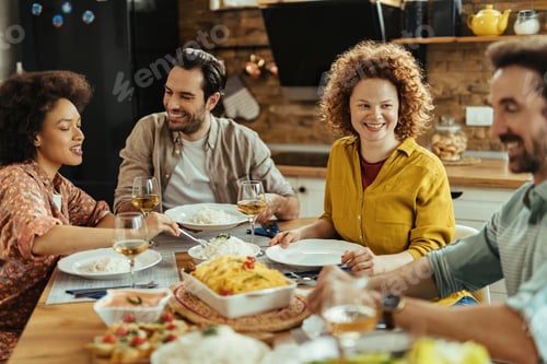 Preview: Young happy woman having lunch with her friends at home.