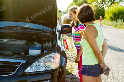 Preview: Sad woman driver with her teenage daughter near broken car on country road