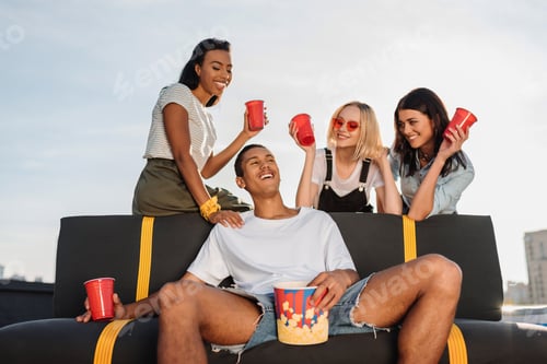 Preview: group of young women flirting with handsome man on party