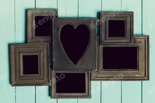Preview: Creative arrangement of empty picture frames on a light blue wooden background