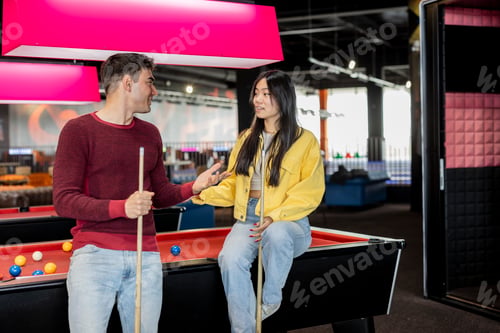 Preview: multiracial couple generation z playing snooker