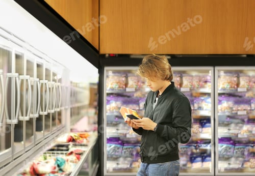 Preview: Man Choosing Frozen Food From A Supermarket Freezer