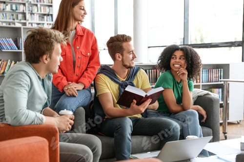 Preview: Group of young people studying at table in library