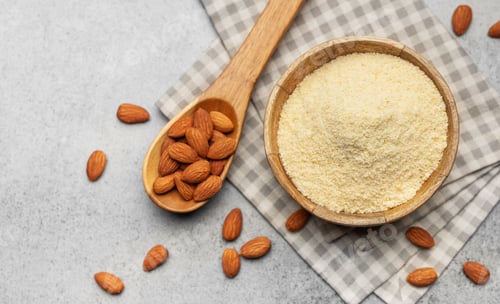 Preview: Fresh almond flour in a bowl and almonds