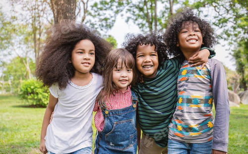 Preview: Children having good time outdoor park, black caucasian children student together