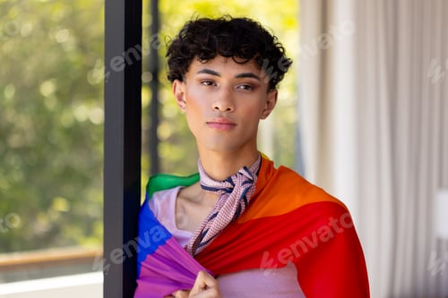Preview: Wearing pride flag, transgender transgender woman standing confidently in living room