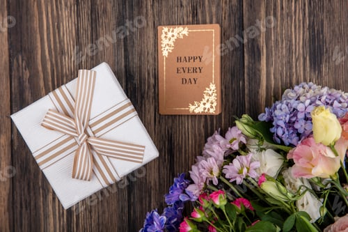 Preview: top view of gift box and flowers with happy every day card on wooden background
