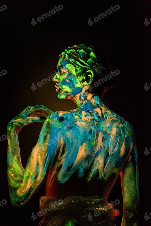 Preview: back view of model with colorful neon paints on body on black background