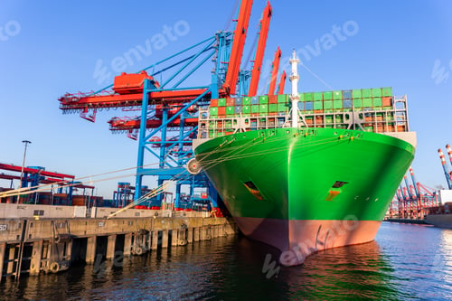 Preview: Scenic view giant cargo container ship loading Hamburg city port harbor against seaport cranes warm