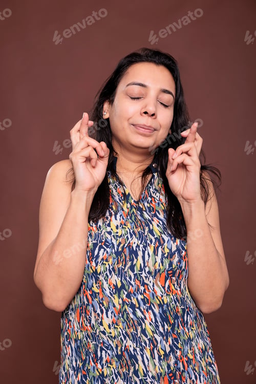 Preview: Indian woman crossing fingers, praying for luck