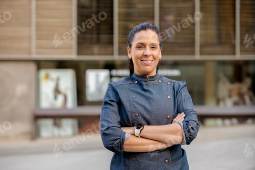 Preview: Female chef broadly smiles on the street