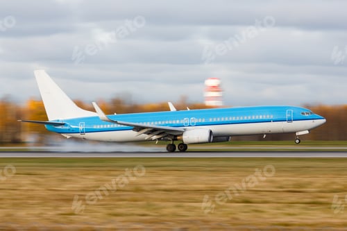 Preview: passenger airplane landing with touchdown on the runway at the airport at sunset, moving