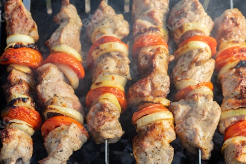 Preview: Grilled pork kebabs meat, pieces of meat on skewers. process of cooking marinated meat on fire.