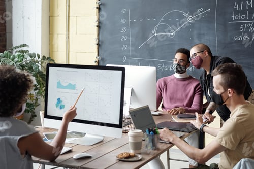 Preview: Group of intercultural managers in masks working in front of computers