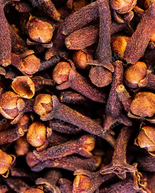 Preview: Vertical closeup shot of details on a pile of brown cloves