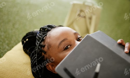 Preview: Black woman and student hiding face with notebook on casual college study lounge bean bag. Shy Afri