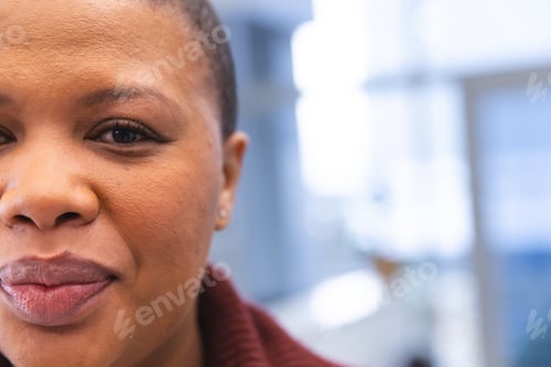 Preview: Portrait of happy african american female patient in waiting room at hospital, copy space