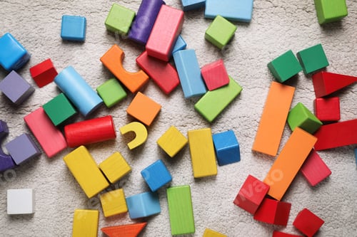 Preview: Colorful wooden building blocks on carpet, flat lay